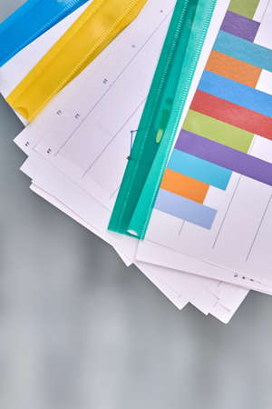 Vertical shot folders with work papers on blurred background. Top view flat lay.の写真素材