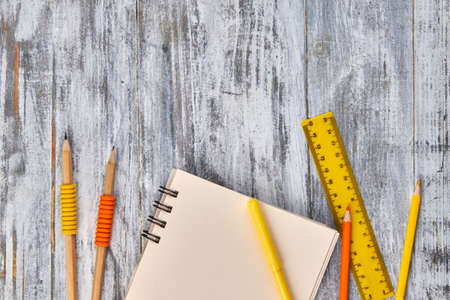 Yellow pencils and ruler on white desk background. Top view flat lay.