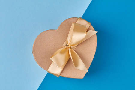 Beautiful heart-shaped gift box on color background. Surprise for Valentines holiday.の写真素材