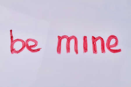 Be mine hand-written iscription isolated on white background. Love message.