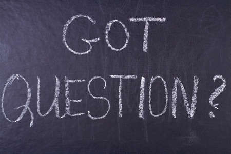 Got question handwritten inscription with white chalk on black chalkboard. Meaning do you have any...