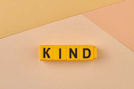 Yellow cubes with word kind on color background close up. Group of people or things having similar characteristics.の写真素材