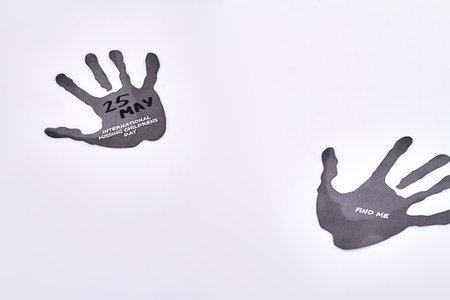 Hands silhouettes on white background. International missing childrens day. Find me message on black...