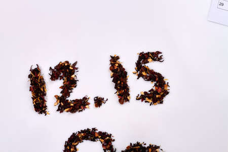 12.15 date made of dry hibiscus petals on white background. Tea day concept. Top view flat lay.の写真素材