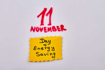 11 november day sticker note with energy saving handwriting. Isolated on white background.