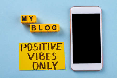 Flat lay smartphone and my blog words. Phone on blue background.