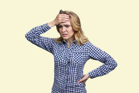 Young worried stressed woman touching her head. Isolated on white background. Headache or problem...