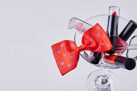 Close up makeup accessories and red bow tie. Isolated on white background.の写真素材