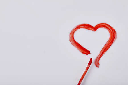 Red heart drawn by mascara on white surface. Valentines day concept.の写真素材