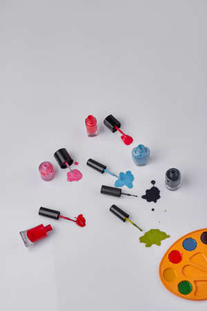 Vertical shot top view nail polishes on white background. Copy space for text.の写真素材