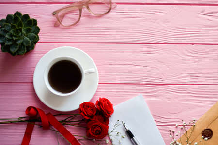 Top view coffee cup with glasses and copy space. Pink wooden desk background.の写真素材