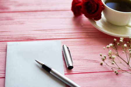 Close up ballpoint pen with blank paper. Pink wood background.の写真素材