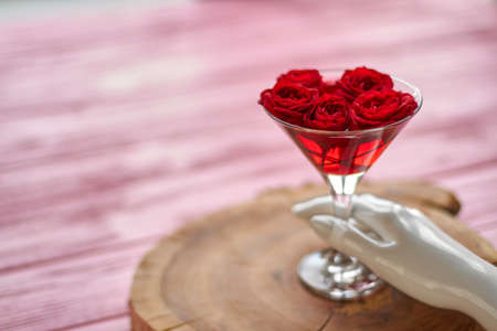 Mannequins hand with cocktail of red roses. Blurred background with copy space.の写真素材