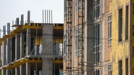Construction workers on the floors of a skyscraper building. Men buliding a new high floor business center.の写真素材
