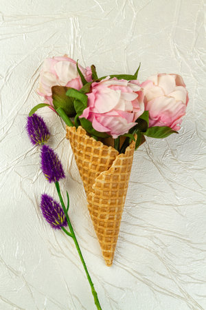 Ice cream cone with flowers and purple clover. Vertical shot white background.の写真素材