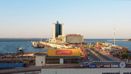 Odesa, Ukraine - 08.08.2020: Hotel Odessa and the cruise ship terminal at Odesa port. Evening urban scape background.のeditorial素材