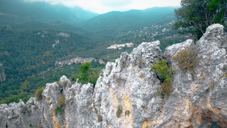 Stone rock texture of the mountain. Panoramic view from above of mountain valley with houses.