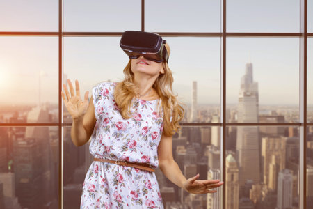 Portrait of a blondie experiences virtual reality in VR headset. Checkered window with metropolis view.の写真素材