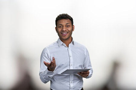 Smiling business trainer holding digital tablet and looking at camera. People, business and modern technology concept.の写真素材