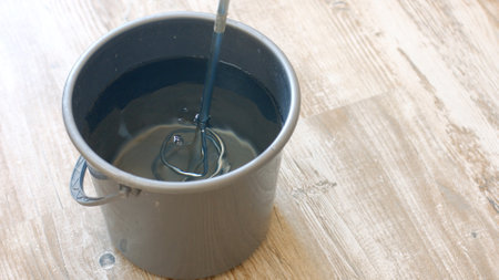 Bucket of water and a construction mixer. Builder knead glue for wallpapering.の写真素材