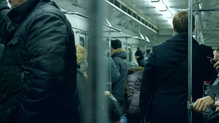 People in the subway. Full wagon of people. People traveling in the train.