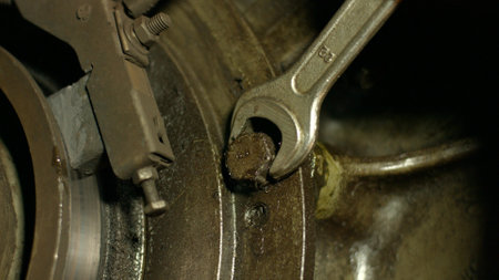 Engine repair. Mechanic tightening the screws. Repair of equipment. Mechanic repairing a car.の写真素材