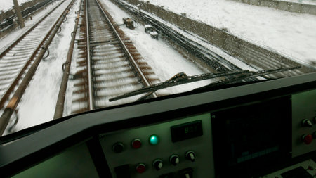 The train is moving along the tracks. Train drivers cabin with a control panel.の写真素材