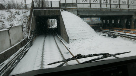 A subway train runs to the station. The train goes through the tunnel on the rails.の写真素材