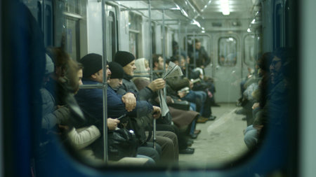 Kyiv, Ukraine - 05.01.2016: People go to work in the subway. A man reads a newspaper in the subway.のeditorial素材