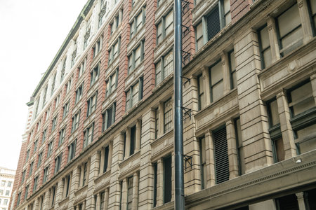 A detailed view of a classic red brick and beige stone building in New York. The architecture...
