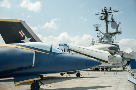 Close-up of the nose and cockpit of Navy jet painted in blue and yellow. The aircraft is stationed...