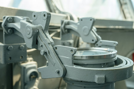Close-up of a gray metal mount used to secure navigation equipment on a ships bridge. The sturdy...