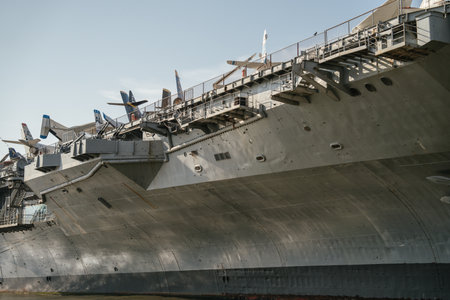 A side close-up shows the aircraft carrier docked in New York City with historic military planes...