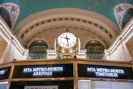 A close-up view of the famous brass clock above the information booth at Grand Central Terminal. The...