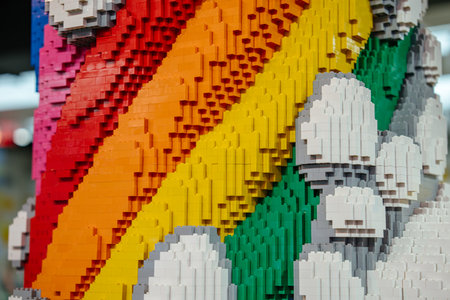 A detailed close-up of a sculpture shows bright rainbow stripes and fluffy white clouds built from colorful bricks. The texture and craftsmanship of the construction are clearly visible.の写真素材