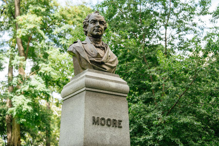 A detailed close-up view of the bronze bust of Thomas Moore in Central Park. The statue rests atop a...