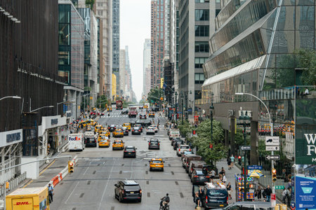 New York City, New York, USA - 08.02.2024: A busy Manhattan street is filled with yellow taxis,...