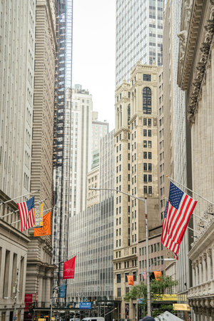 New York City, New York, USA - 08.03.2024: American flags hang along Wall Street in New York City...