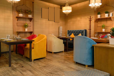 Cozy interior in the restaurant with chairs and with three tables, in beige tonesのeditorial素材