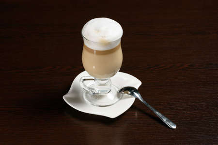 Coffee cappuccino in a glass Cup on a wooden table. Photos for restaurant, cafe and bar menusの写真素材