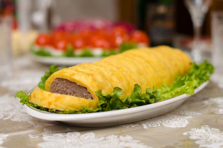 Meatloaf with cheese and lettuce leaves on table for New Year and Christmasの写真素材