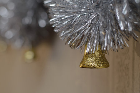 Christmas golden bell and silver garland close-upの写真素材