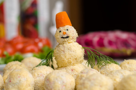Salad in the form of a snowman and balls of cheese and crab sticks for the New Year and Christmasの写真素材