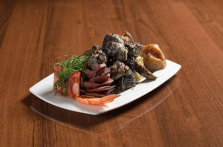 Uzbek Asian cuisine Hasip, meatballs with rice and minced meat in a white plate on the tableの写真素材