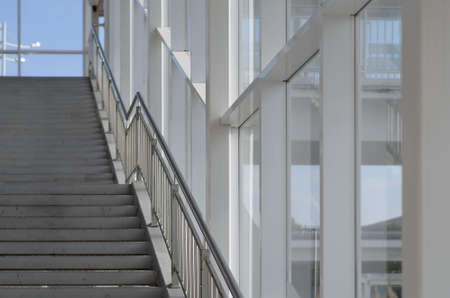 Empty staircase in an elevated passage with large windows