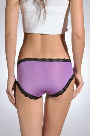 Different models of women's panties on a beautiful body of a young athletic and healthy girl isolated on a white backgroundの写真素材