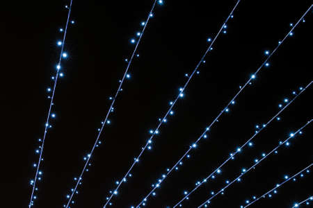 Bright festive lines of cold flickering lights on a black background