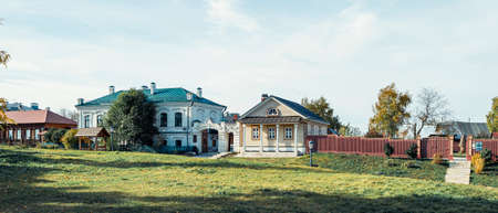 The old street in the Russian village. Wooden houses and fences.