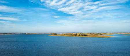Uninhabited islands on the Volga River. Beautiful river and cloudy sky. Panoramic view.の写真素材