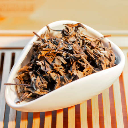 Aged white Chinese tea Lao Shou Mei or Longevity Eyebrows in tea presentation vesselの写真素材